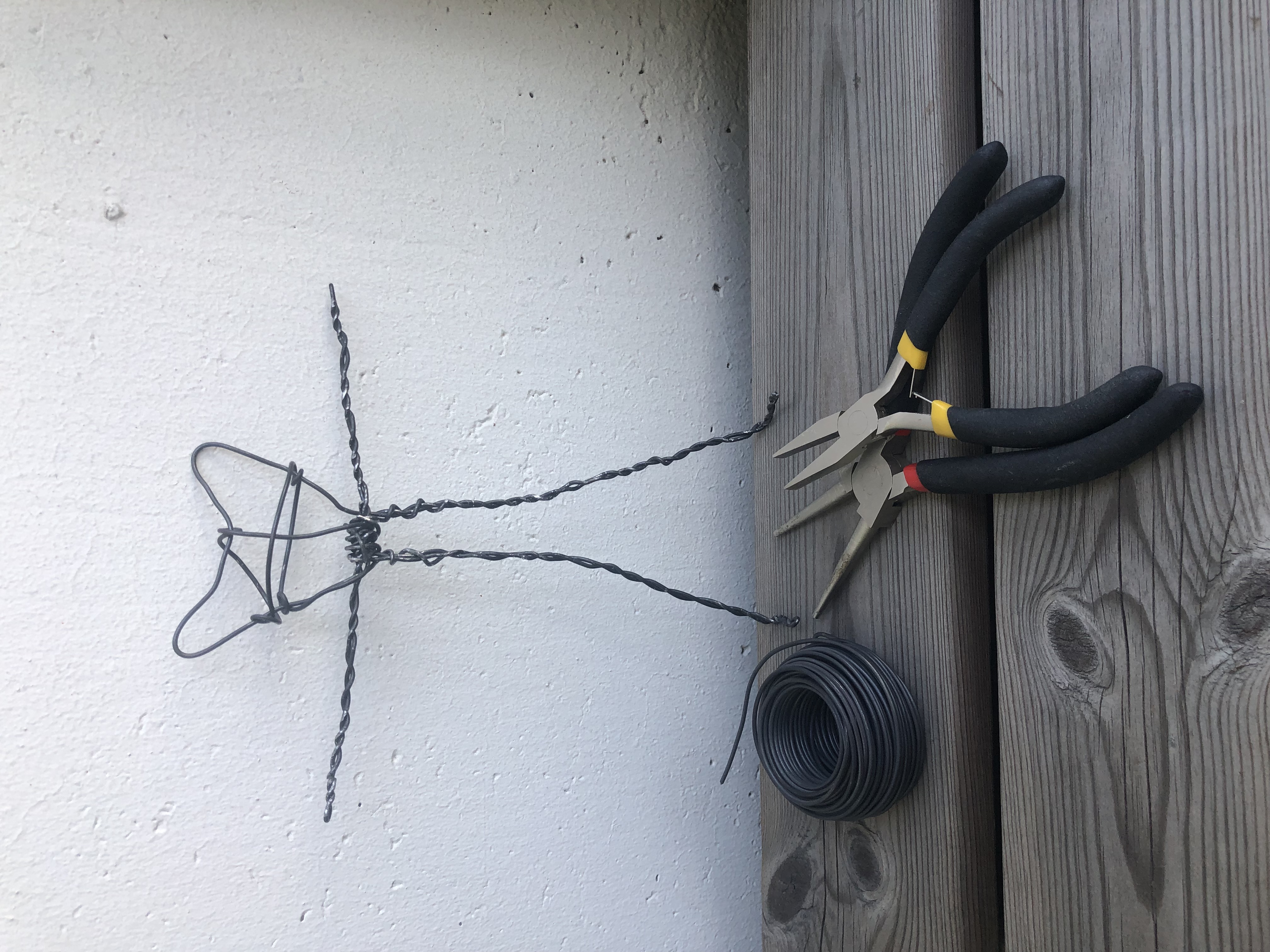 A wire skeleton of a Yarny doll and some tools